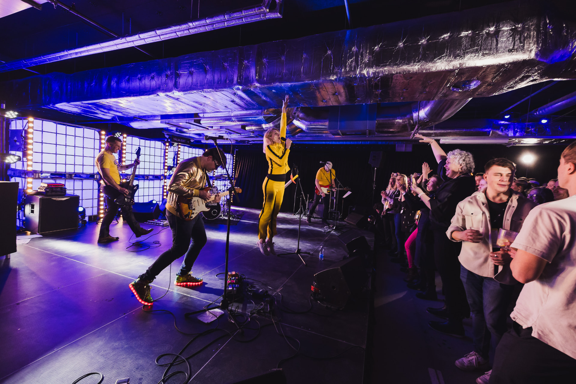 Minimal Viable Band on stage with an active crowd at a tech event